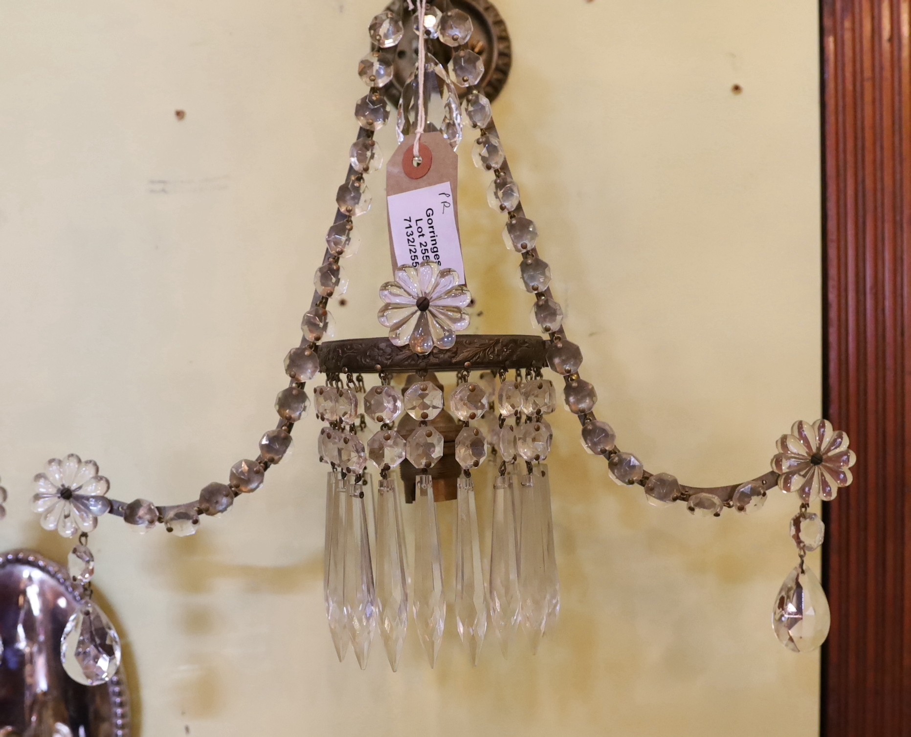 A pair of 1930s English bronze and glass wall lights, of outswept form with central bulb holders ringed with lustre drops, height 34cm. width 34cm